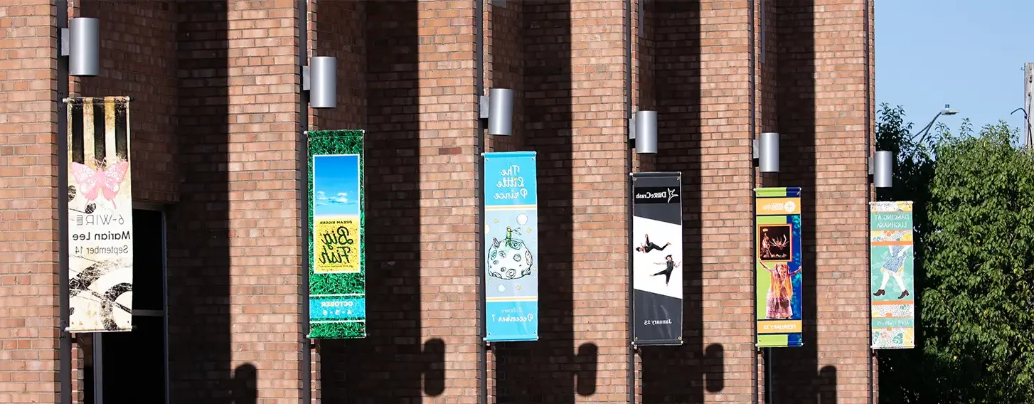 A row of signs hanging from the Galvin Fine Arts Center.